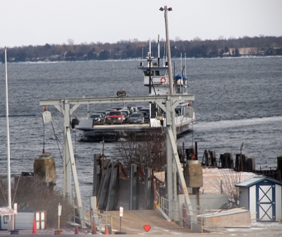 [Car ferry with 3 columns of cars coming toward the loading dock.]